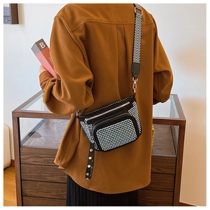 Detail of rhinestone crossbody bag with black white geometric wide strap and silver buckles