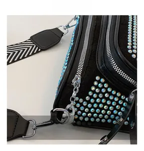 Detail of high-quality silver zipper and rhinestone surface on black crossbody bag