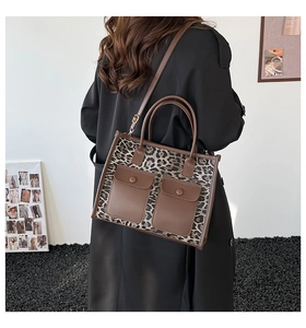 Rear view of a model wearing a leopard print tote bag with dual front pockets