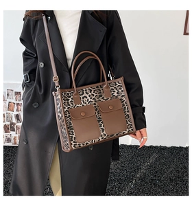 Detail of leopard print tote bag with dual front pockets and adjustable strap