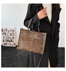 Detail of leopard print tote bag with brown leather pockets and high-quality canvas texture