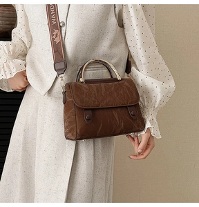 Deep brown crossbody bag featuring retro wrinkled texture and gold metal curved handle