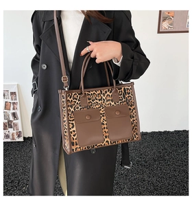 Detail of leopard print tote bag with brown leather front flap pockets and straps