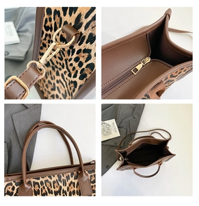 Detail of leopard print tote bag showing gold hardware hooks and reinforced stitching
