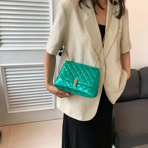 Chic quilted crossbody bag in metallic green with a gold chain strap for women