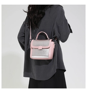 Detail of pink and silver mixed color crossbody bag with metallic texture finish