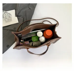 Spacious interior of leopard print tote bag holding a tablet, umbrella, and essentials