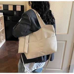 Detail of cream large tote bag with textured faux leather and matching coin purse pouch