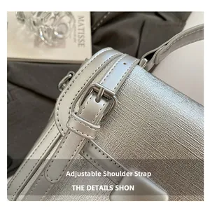 Close-up of adjustable silver shoulder strap and woven textured surface of the bag