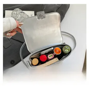 Interior view showing capacity and pockets of silver crossbody bag for daily essentials