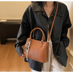 Brown lychee pattern tote bag with silver FASHION BAG text and chocolate charm detail