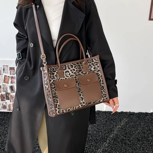 Chic leopard print tote bag with brown leather accents and front buckled pockets for women