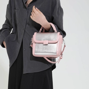 Fashionable pink and silver contrasting leather handbag with crossbody strap for women