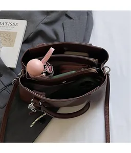 Macro view showing large capacity and multi-compartment interior of lychee leather bag