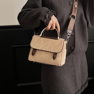 Elegant khaki tote bag with paper-like texture, metal handle and wide shoulder strap
