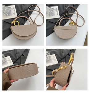 Detail view of champagne saddle bag featuring metallic woven texture and gold ring handle