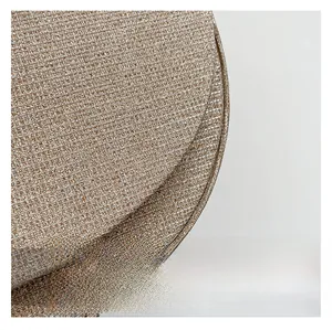 Close-up of champagne gold woven fabric showing fine metallic texture and curved edge