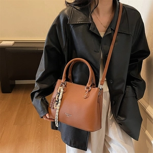 Chic lychee pattern leather tote bag in caramel brown with dual handles and crossbody strap