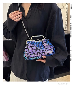 Detail of sequin mosaic evening bag with silver metal hinge and detachable chain strap