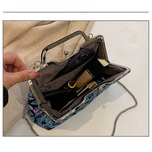 Interior view showing capacity for smartphone and cosmetics in the sequin shell evening bag
