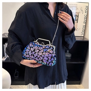Close-up of sparkling blue and purple gradient sequins on a shell-shaped evening bag