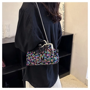 Detail of colorful geometric sequin shell bag with silver chain strap and metal clasp
