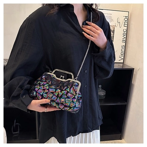 Detail of colorful geometric sequin shell bag with silver metal handle and chain strap