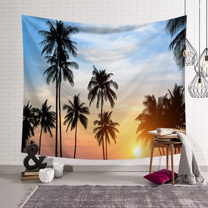 Detail view of sunset tropical palm tree tapestry hanging on a white brick living room wall