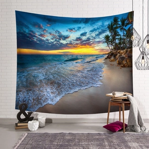 Detail of beach sunset tapestry with coconut trees hanging on a white brick wall