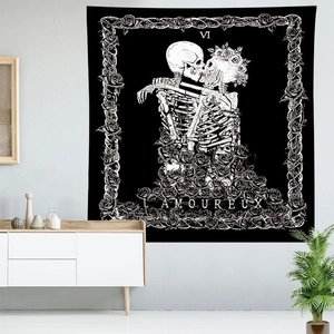 Macro detail of Tarot The Lovers tapestry featuring skull artwork and floral borders