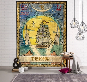Detail of The Moon tarot tapestry hanging on a brick wall in a cozy indoor setting