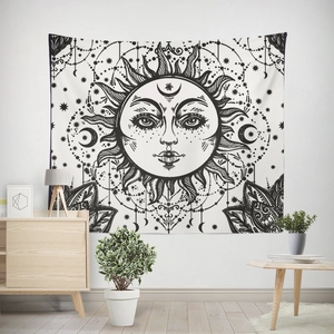 Detail of sun and moon tapestry with celestial patterns on a modern white wall