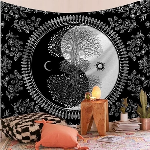 Detail of bohemian tapestry featuring tree of life and yin yang pattern on black background