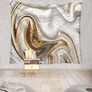 Detail of marble texture tapestry with golden fluid art hanging in a modern bedroom