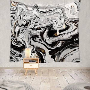 Modern black, white, and gold marble tapestry hanging as a backdrop in a minimalist room