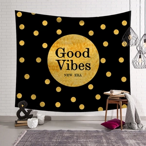 Detailed view of Good Vibes tapestry on a white brick wall with modern home decor