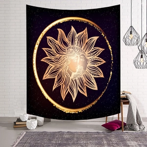 Bohemian gold sun and moon tapestry hanging on a white brick wall for home decor