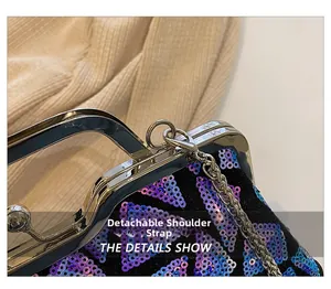 Detail of laser sequins and detachable silver metal chain on the shell evening bag