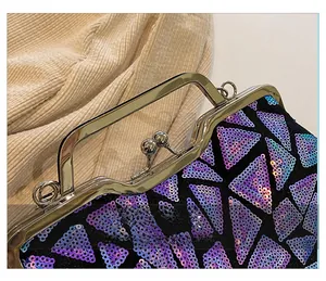Detailed close-up of metallic clasp and purple sequins on luxury shell clutch bag