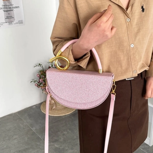 Pink crescent handbag with sparkling woven texture and golden twisted metal handle