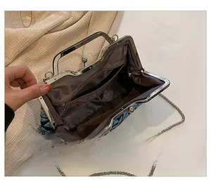 Internal view of shell clutch with colorful sequins, chain strap and zipper pocket