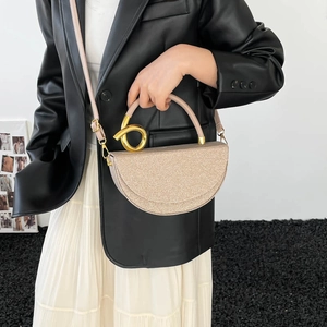 Sparkly champagne half-moon bag with golden spiral ring handle and detachable strap