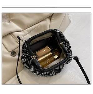 Detail showing the internal capacity of the rhinestone cloud clutch bag with essentials