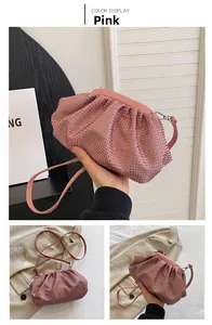 Detailed view of pink pleated cloud bag featuring shimmering rhinestones and slim strap