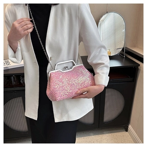 Close-up of pink sequin evening bag with silver metal handle and vintage clasp