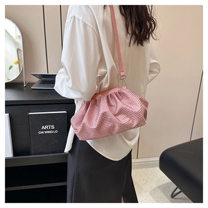 Detail of pink rhinestone pleated cloud bag with elegant fabric folds and fine crystals