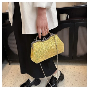 Detailed shot of yellow sequined evening clutch bag with retro silver metal clasp and chain