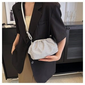 Detail of white rhinestone cloud bag showing sparkling crystals and slim shoulder strap