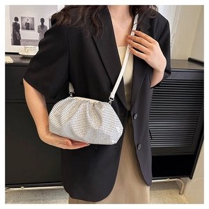 Silver rhinestone dumpling bag with pleats shown on model with shoulder strap