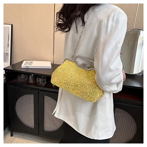 Detailed view of yellow sequin evening bag with silver metal kiss-lock and chain strap